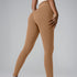 Model in camel-colored athletic leggings and cream top, side pose showing seamless fit on gray backdrop