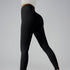 Model wearing black high-waisted athletic leggings and ivory long-sleeve top, front view on gray background