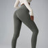 Model in olive green high-waisted leggings and cream top, side angle showing seamless fit on gray backdrop