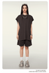 Female model in chocolate brown oversized tee and matching shorts set with chunky sneakers and sunglasses