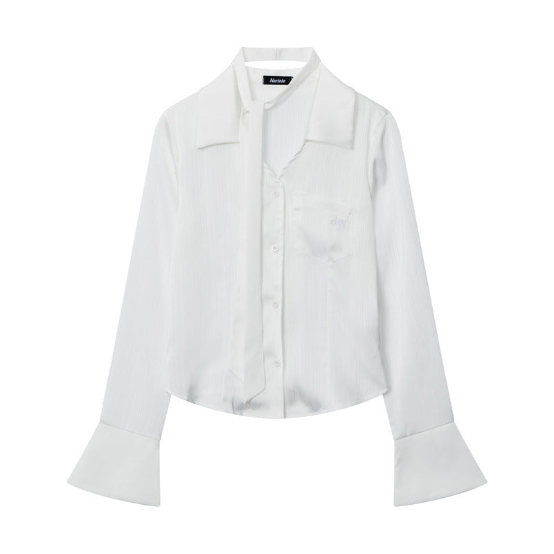 White button-up blouse with wide cuffs and collar, laying flat