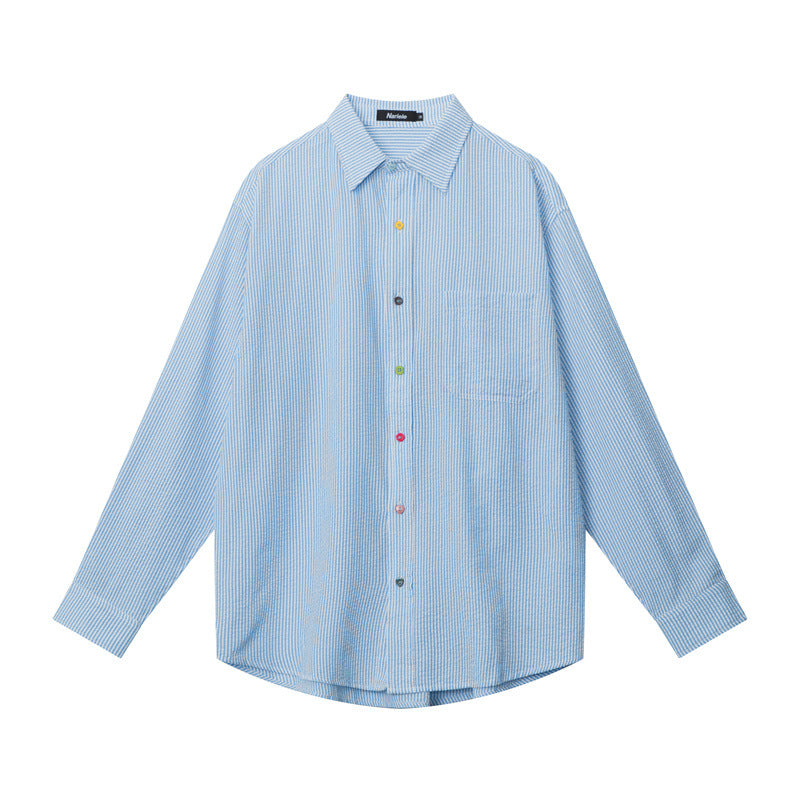 A flat-lay of a blue striped button-up shirt with a classic collar, chest pocket, and multicolored buttons, displayed against a white background