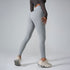 A model wearing light gray high-waisted leggings with textured crop top, showing side view profile against gray backdrop