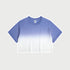 Purple and white ombré cropped short-sleeve t-shirt with gradual color fade from deep blue to white, featuring a crew neck and a small branded tag at the collar