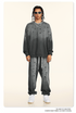 GIF showing model rotating to display gray splatter-print sweatsuit with silver chains and white sneakers