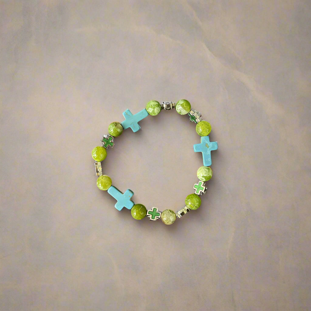 A vibrant beaded bracelet with green and turquoise beads, featuring turquoise cross-shaped beads and metallic green cross accents