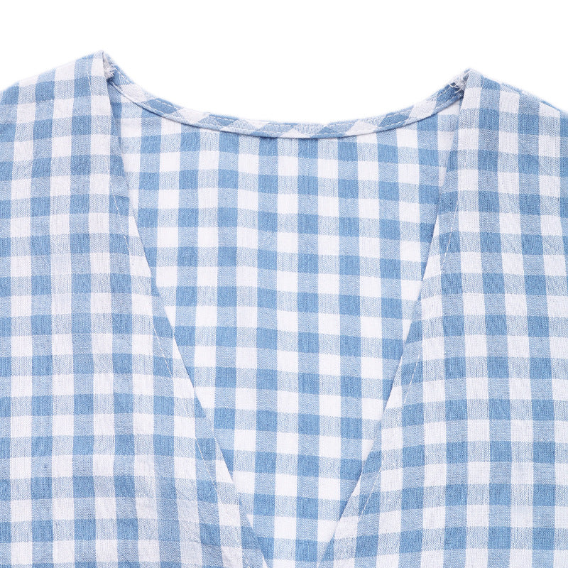 Detail shot of the top’s deep V-neckline and neatly stitched fabric, showcasing the precise pattern alignment.