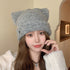 Gray Cat Ear Beanie Hat Styled with Jewelry – Elegant gray cat ear beanie hat paired with a necklace for a fashionable winter look