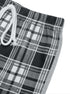 Side view of plaid pants highlighting contrast stitching and elastic waistband detail.
