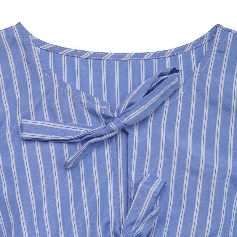 A detailed view of the neckline and bow-tie closures of the blue striped dress.