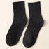 A pair of black ribbed crew socks displayed flat against cream background showing texture and full length
