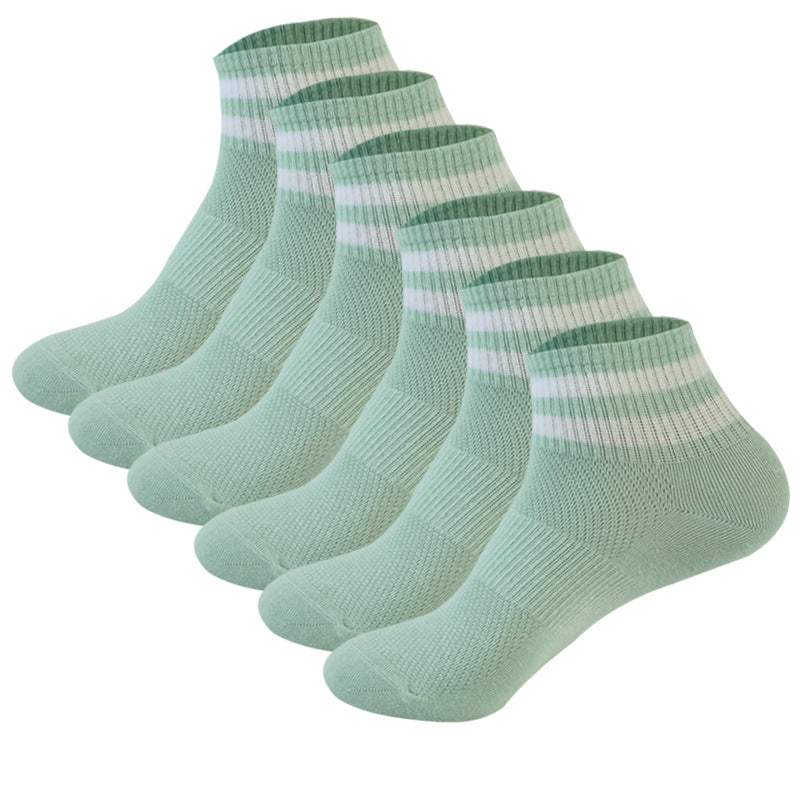 Six-pack of mint green ankle socks with white striped cuffs, arranged in a row showing ribbed texture and design