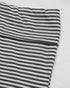 Close-up of the waistband of the black and white striped pants, highlighting the stretch and comfort.