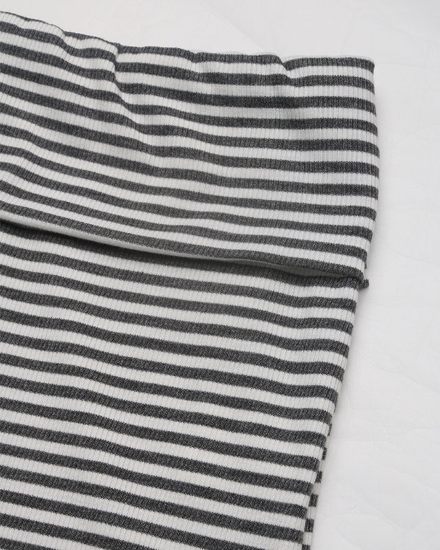 Close-up of the waistband of the black and white striped pants, highlighting the stretch and comfort.