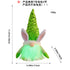 Green LED bunny gnome plush toy with striped arms and sequined hat, glowing and measured for reference.