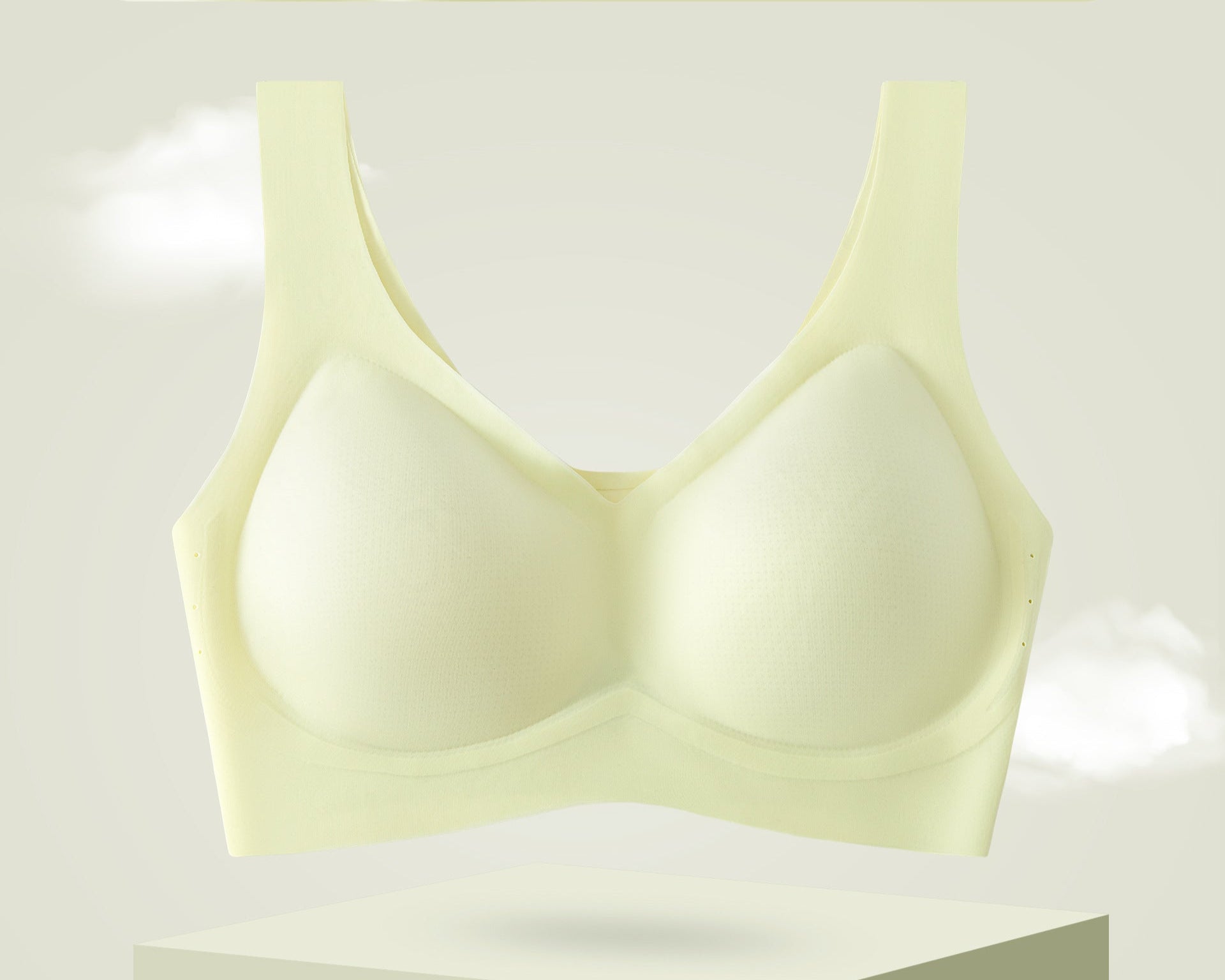 Summer green seamless bra with breathable cups on a pedestal.