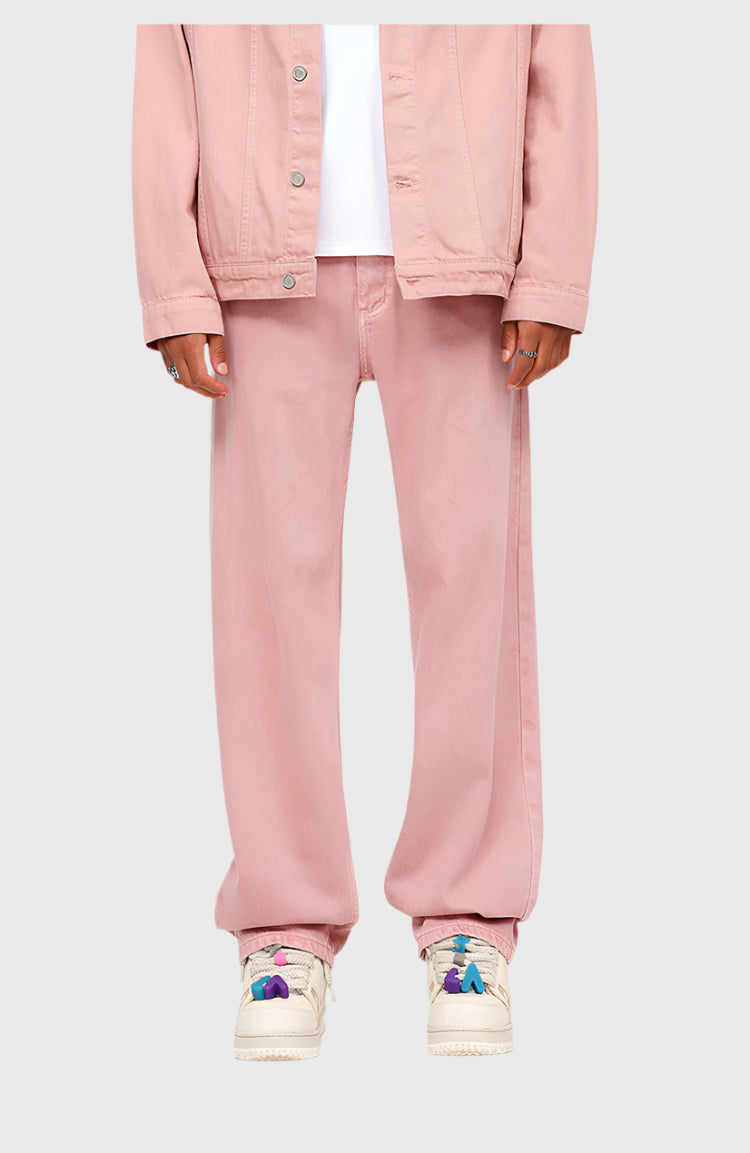 Pink denim set with cropped jacket and wide-leg pants, paired with colorful sneakers