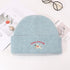 Baby blue ribbed beanie with Lucky Pipiegg puppy embroidery on white background