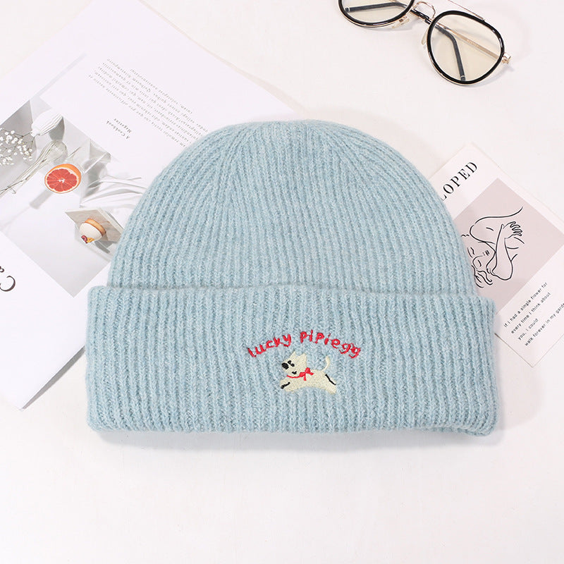 Baby blue ribbed beanie with Lucky Pipiegg puppy embroidery on white background