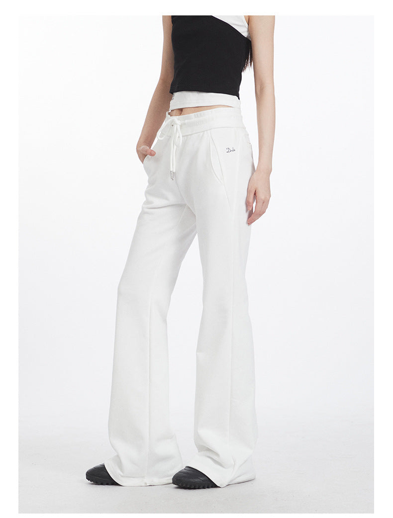 White flared yoga pants with drawstring waist and side pockets