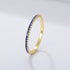 Blue sapphire eternity band in gold setting featuring deep royal blue stones in delicate prong design