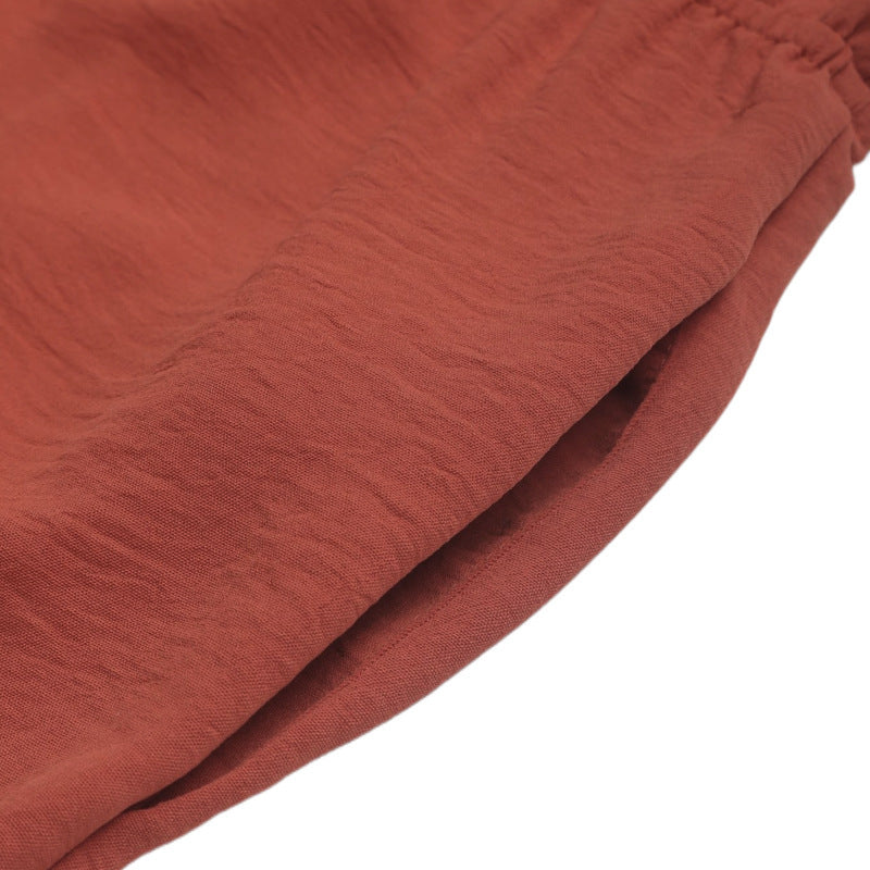 A close-up of the jumpsuit's side pocket, showcasing the stitched hem and lightweight fabric.
