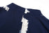 Detailed view of the back neckline of a navy jumpsuit with a button closure and keyhole cutout.