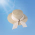 Beige women's wide brim straw hat with a stylish bowknot and crystal detail. A fashionable and functional sun hat for outdoor elegance.