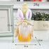 A yellow LED bunny gnome with a floral hat and striped sleeves, glowing warmly, standing at 17cm with measurement annotations.