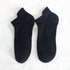 Pair of black athletic ankle socks with ribbed arch support design