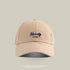 Beige baseball cap with navy 'Naivety 1768' embroidered logo, front view