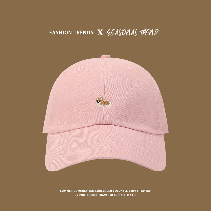 Pink baseball cap with small embroidered corgi logo, casual summer style
