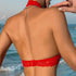 A woman's back view showing a red lace bralette with an open back design and chain necklace detail