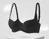 Classic black push-up bra with soft wireless support and a sculpted fit, displayed on a modern floating background.