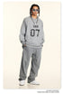 Full-length shot of model in gray 'ERA 07' loungewear set with white sneakers