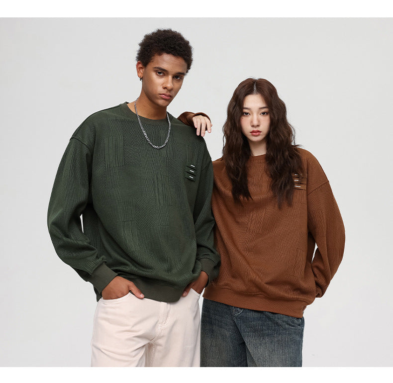 Two models posing against white background - one in olive textured sweatshirt with white pants, another in brown textured sweatshirt with denim culottes