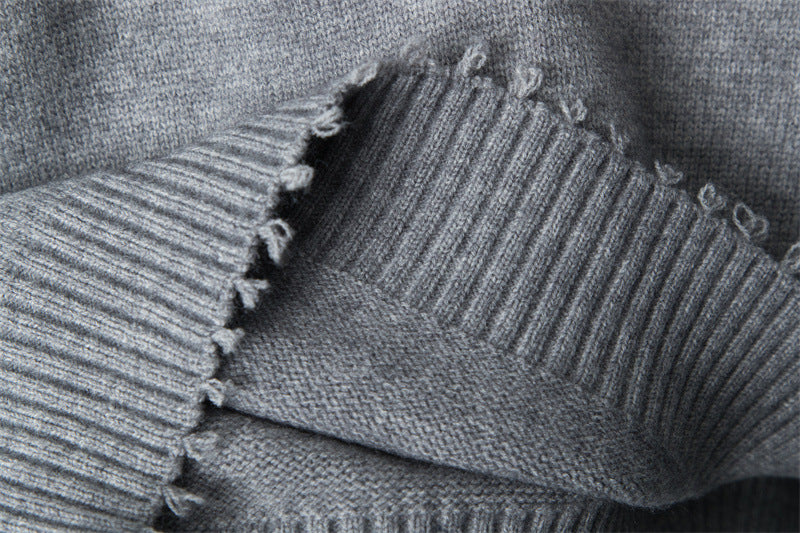 Close-up of V-neck ribbing construction, showing intersection of knit patterns.