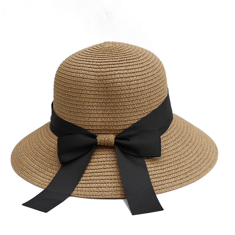Khaki straw sun hat with a black ribbon bow, featuring a wide brim for elegant summer wear.