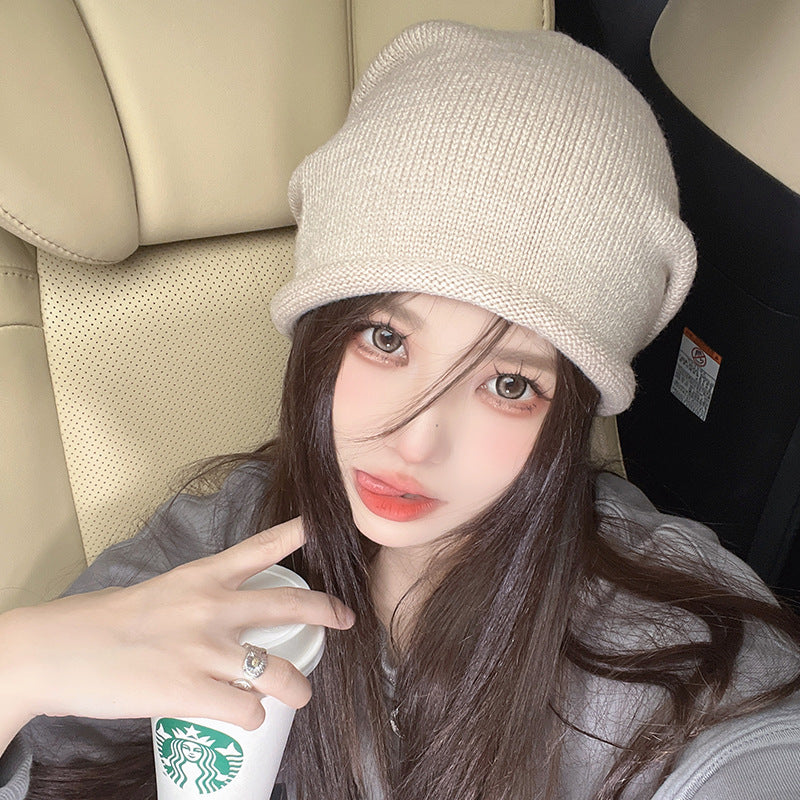 Car selfie with beige beanie hat and Starbucks drink, casual style