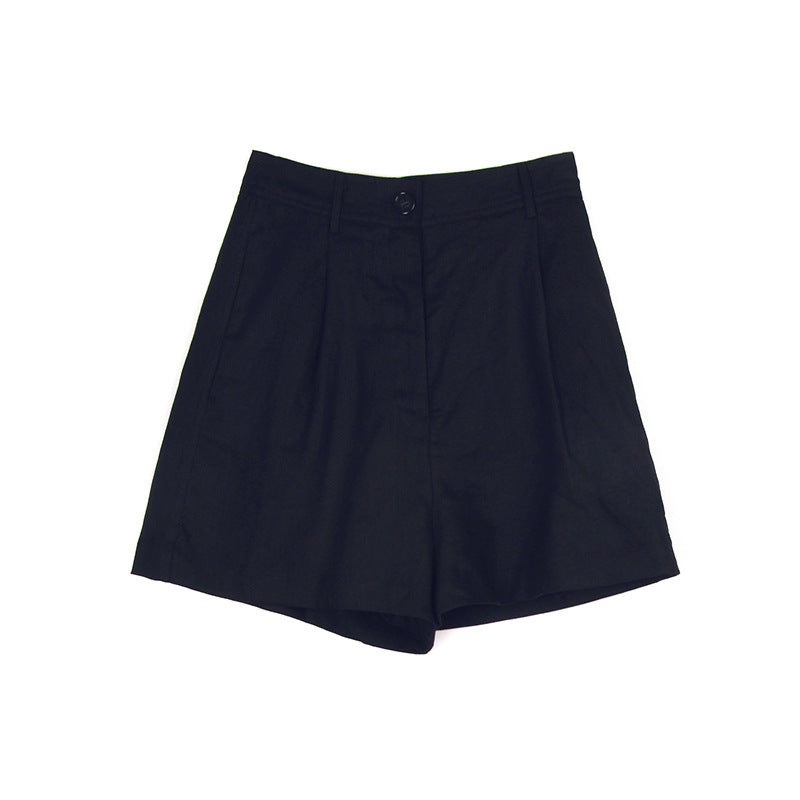 Navy blue linen shorts with front pleats and clean tailoring photographed against white backdrop