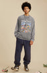 A male model wears a gray oversized "RECOLLECT" sweatshirt with a bold print, posing with hands in pockets