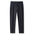 Navy blue pleated dress trousers with belt loops and front button closure on white background
