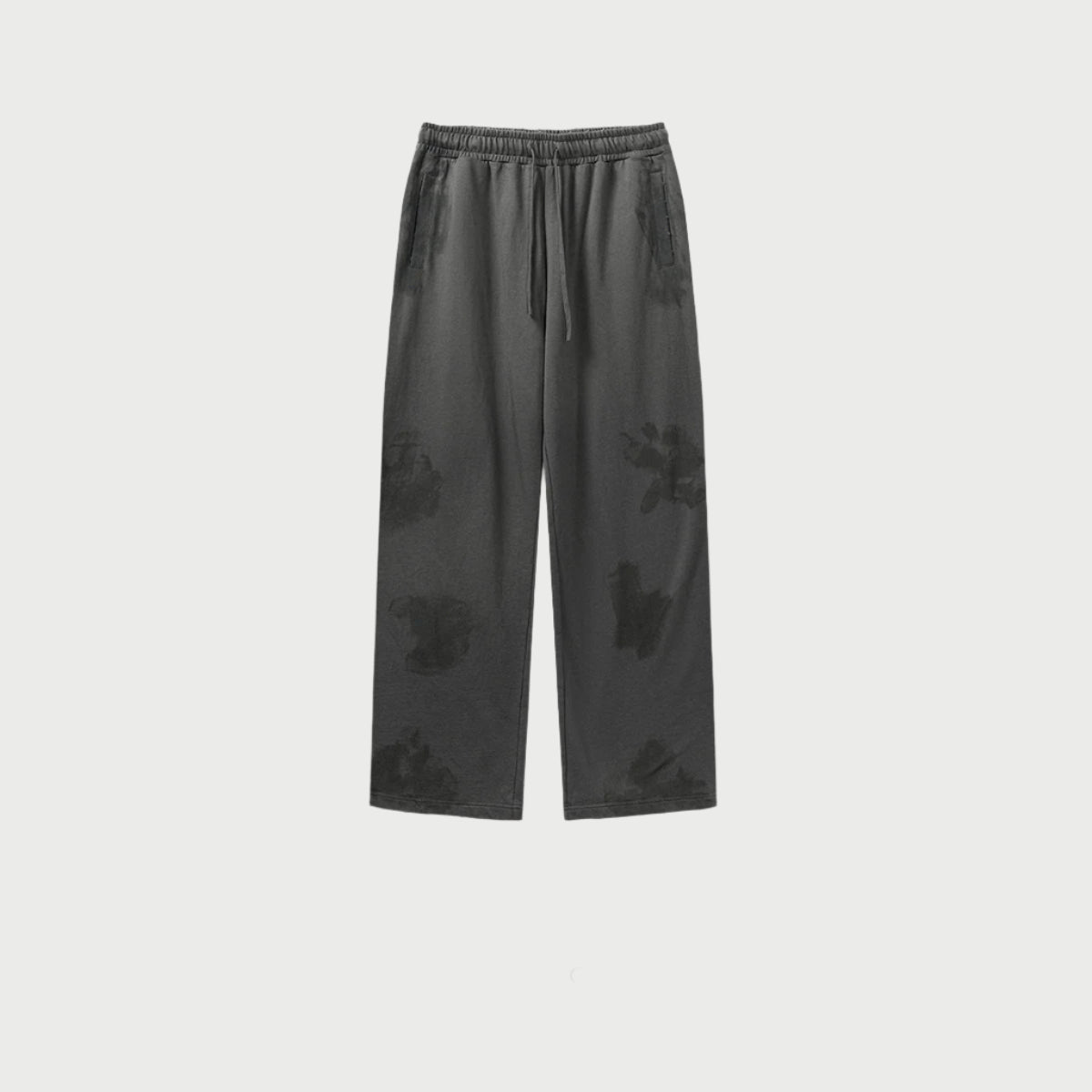Charcoal grey drawstring pants displayed flat showing distressed pattern and side pockets. Features elastic waistband and relaxed fit