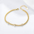 Gold chain bracelet with three small heart-shaped CZ charms.