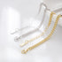 Close-up of gold and silver bracelet chains with lobster clasps and extender tags.