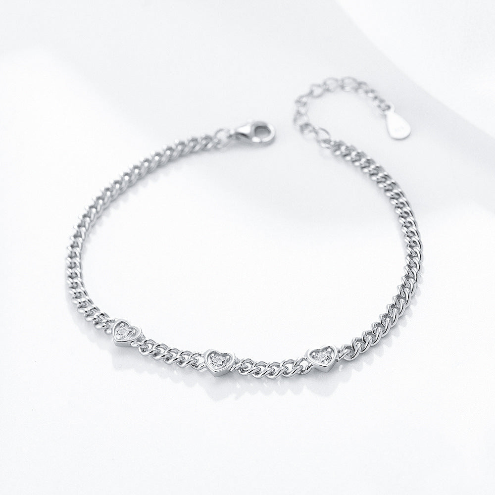 Silver version of heart charm bracelet with three CZ heart accents.