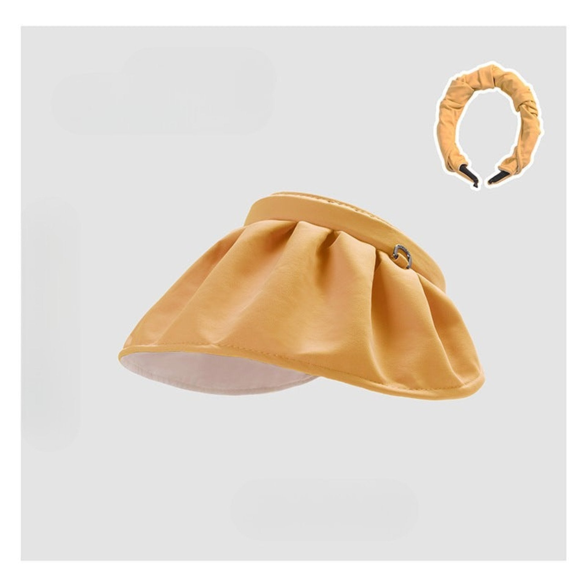 A warm yellow shell hat with an adjustable scrunchie-style band, designed for a chic, effortless style.