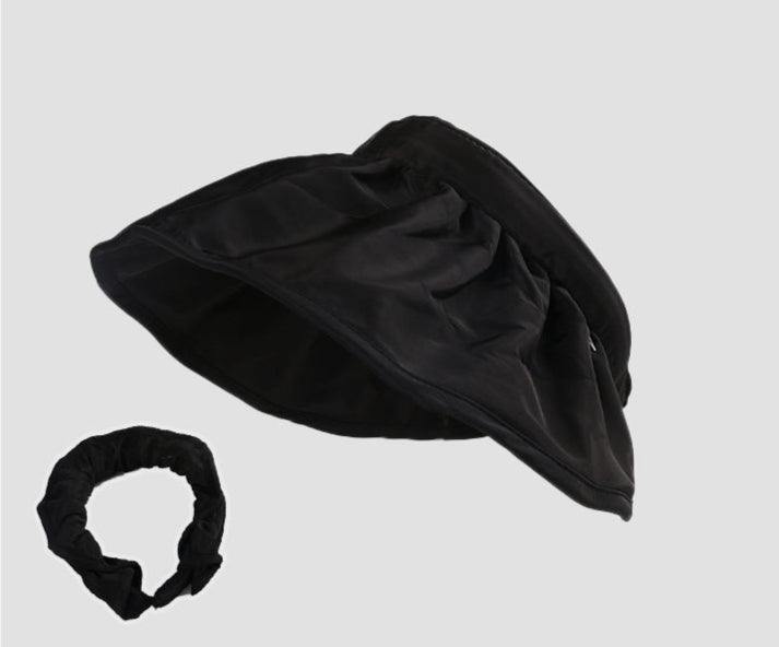 A black sun visor hat with a ruched fabric headband, designed for sun protection and a sporty-chic look.