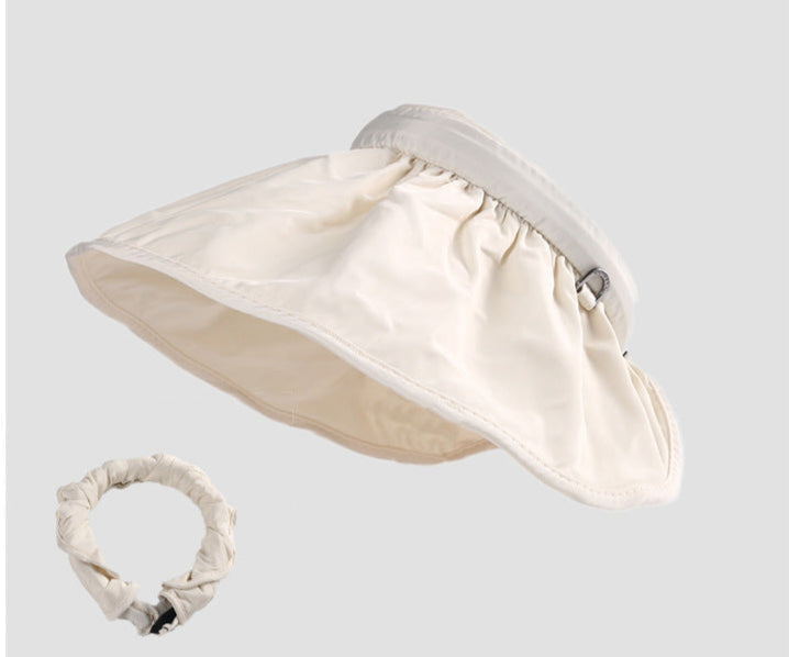  A cream sun visor hat with a matching ruched headband, designed for sun protection and style.