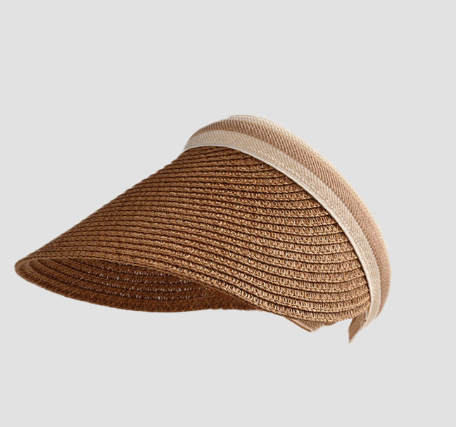 A stylish khaki-colored straw visor with a curved brim and beige trim, perfect for sun protection and summer outings.